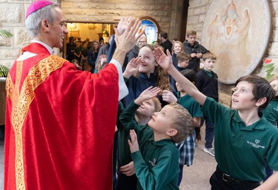 Bishop-elect Izen engages students at Mass — by name