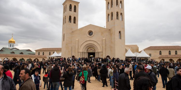 Thousands gather at the Jordan River with patriarch to mark the baptism of Jesus