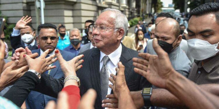 Malaysian ex-PM’s jail term halved to six years